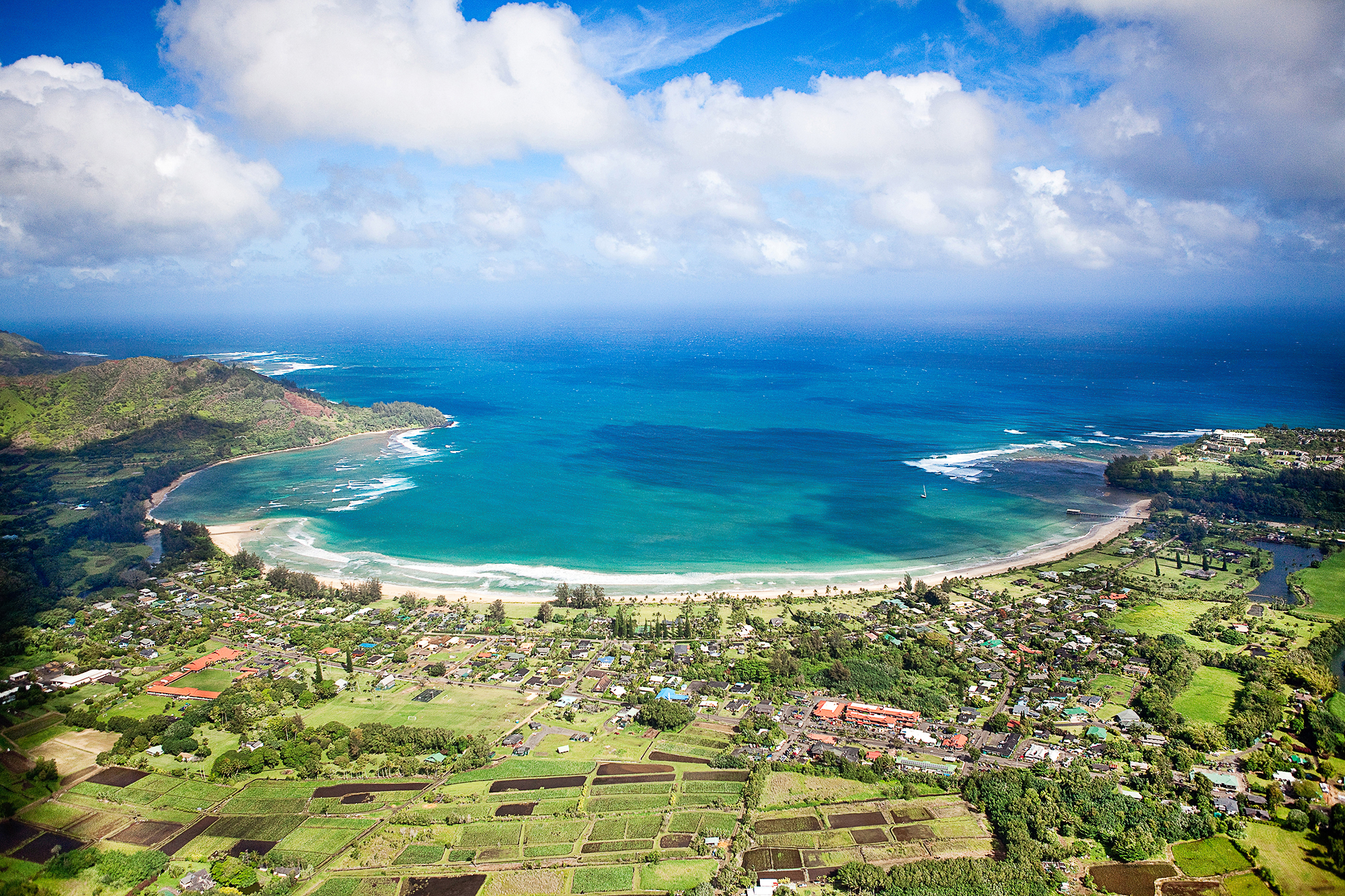 Aerial view of Hanalei Bay, Kauaʻi — buying a vacation rental on Kauaʻi in a planned resort community