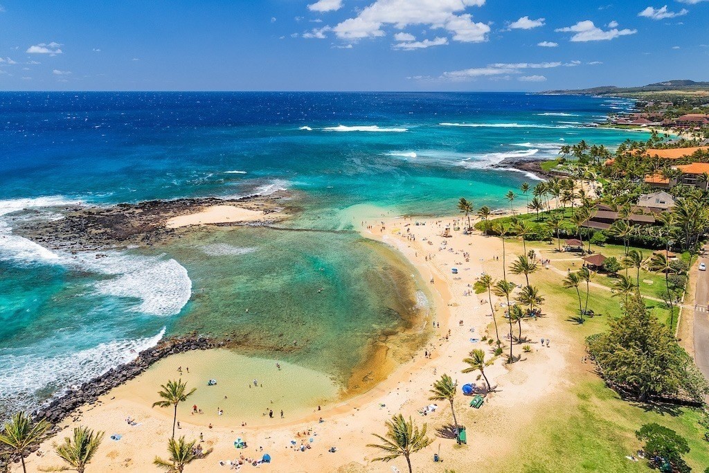 Poʻipū Beach on Kauaʻi's South Shore — sunny skies and calm water